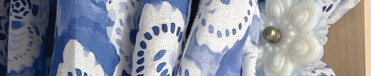 Eskayel's Margherita fabric in the colorway Fresco blue presents petals and blooms as a loose lattice in a in arich blue palette.