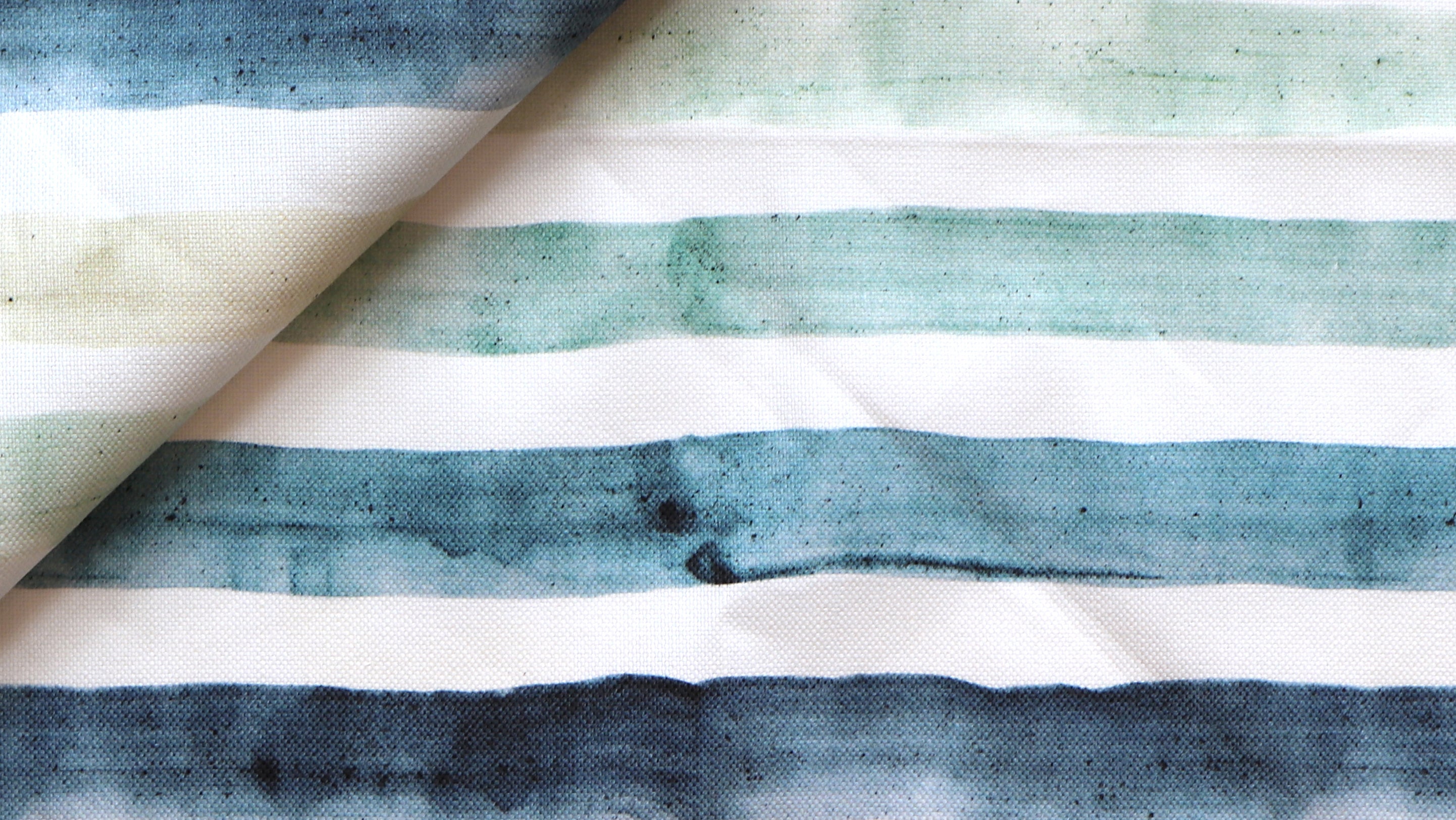 A close up of a blue and green striped fabric