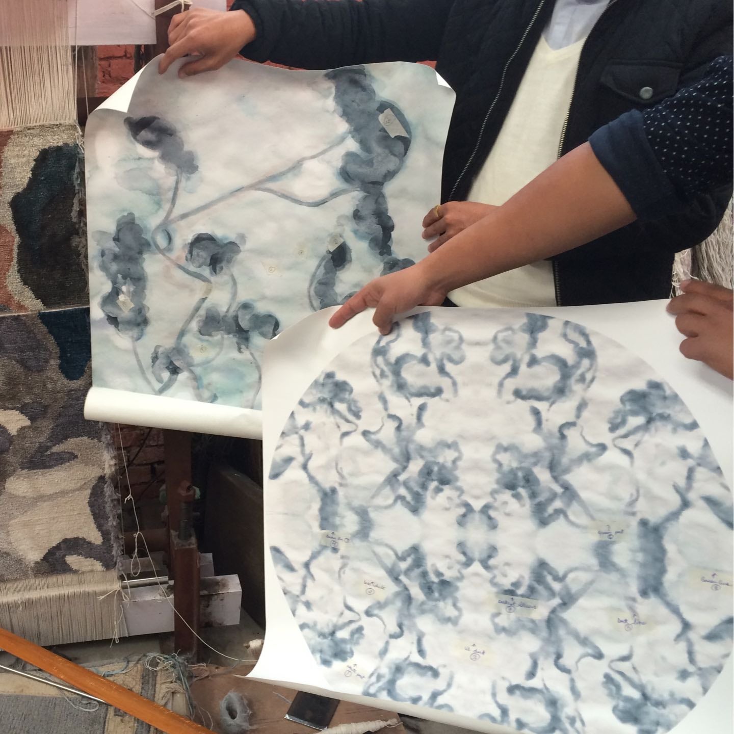 A group of people standing next to a large piece of paper