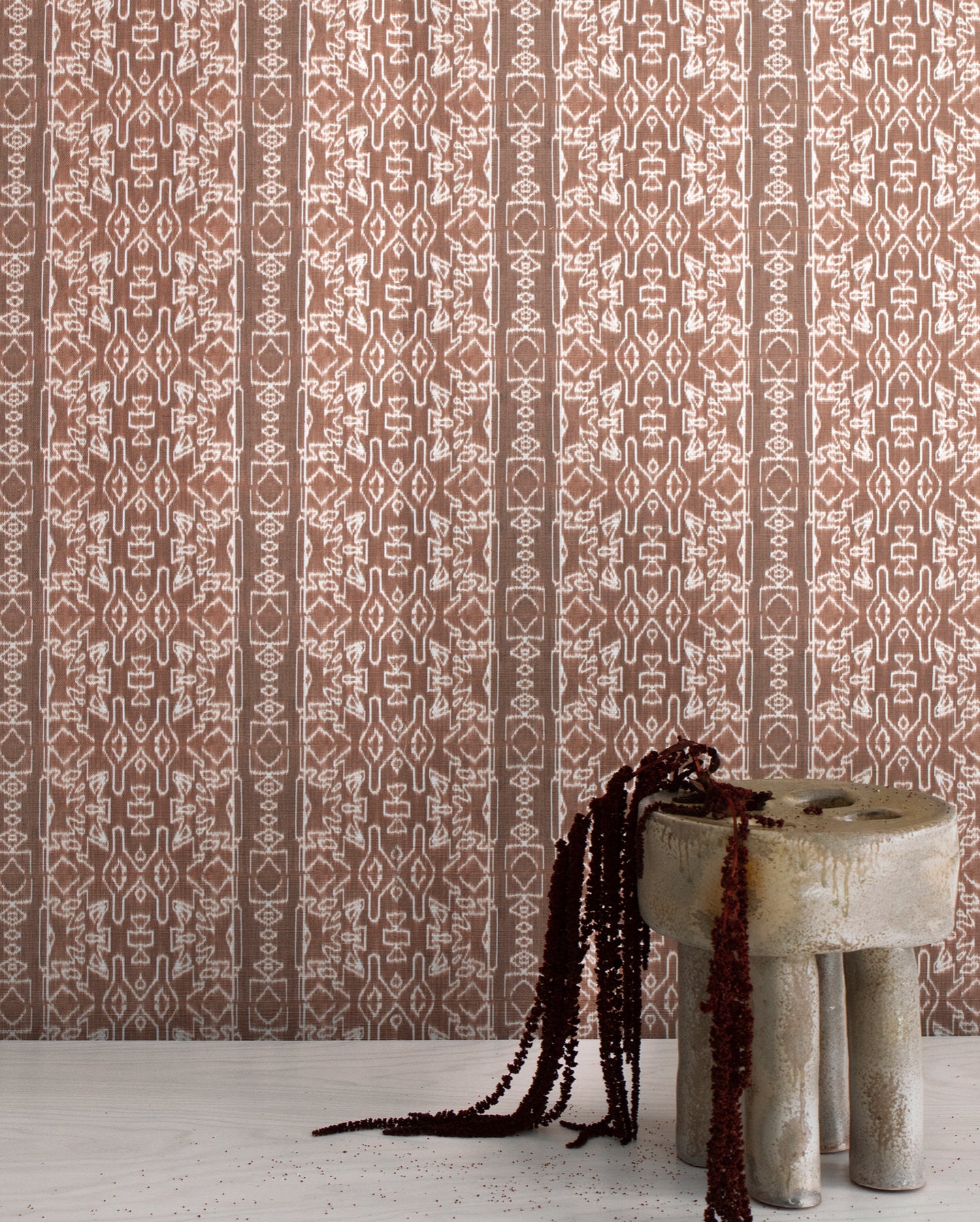 A brown and beige wallpaper with a stool in front