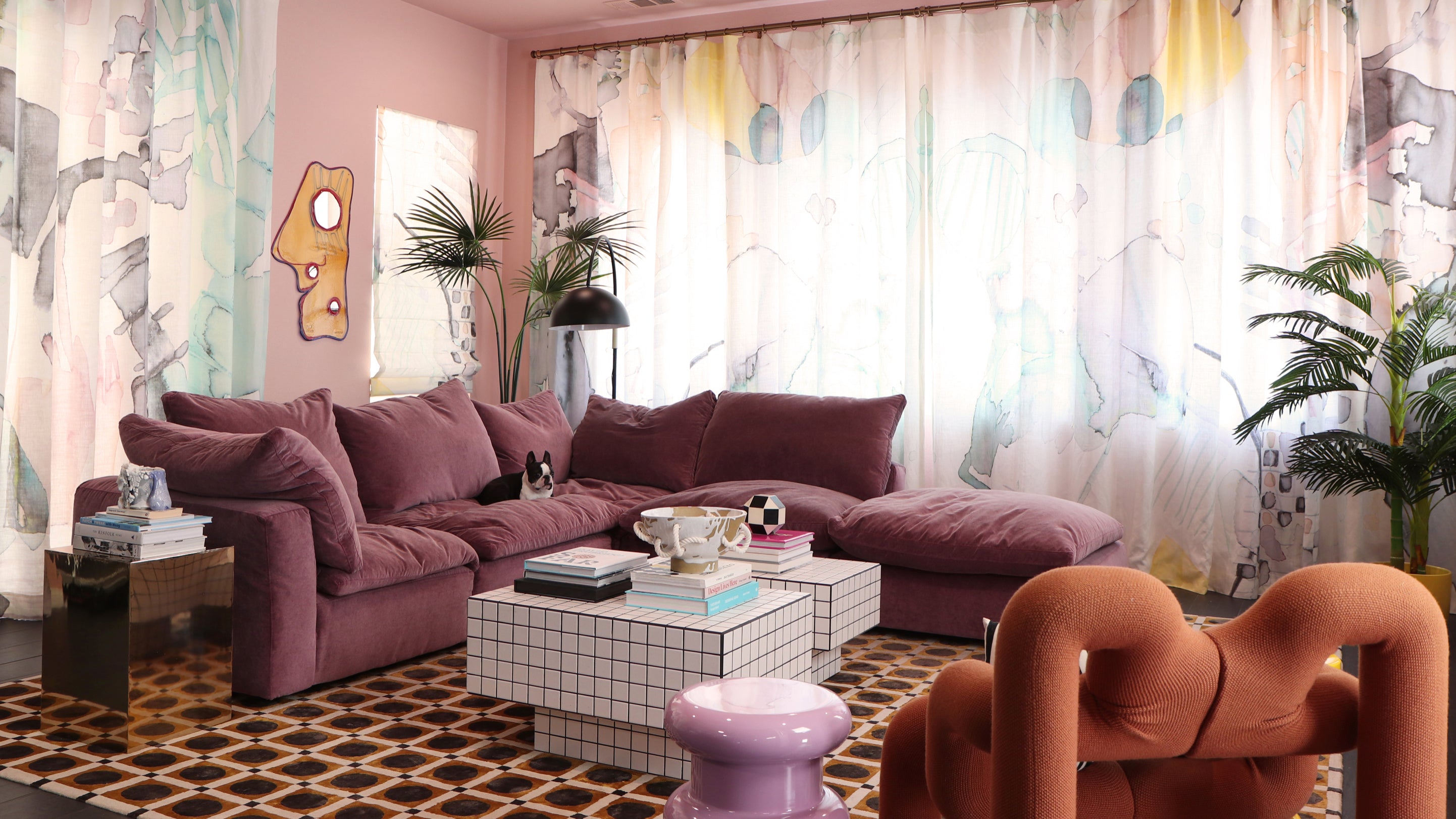 A living room with a pink couch and a coffee table