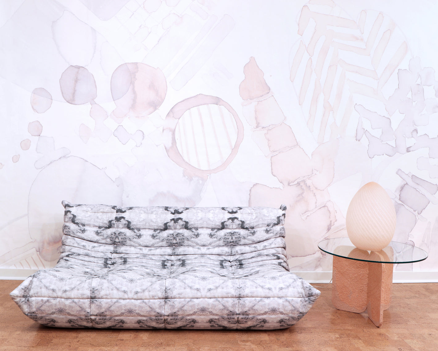 A white couch in front of a white wall