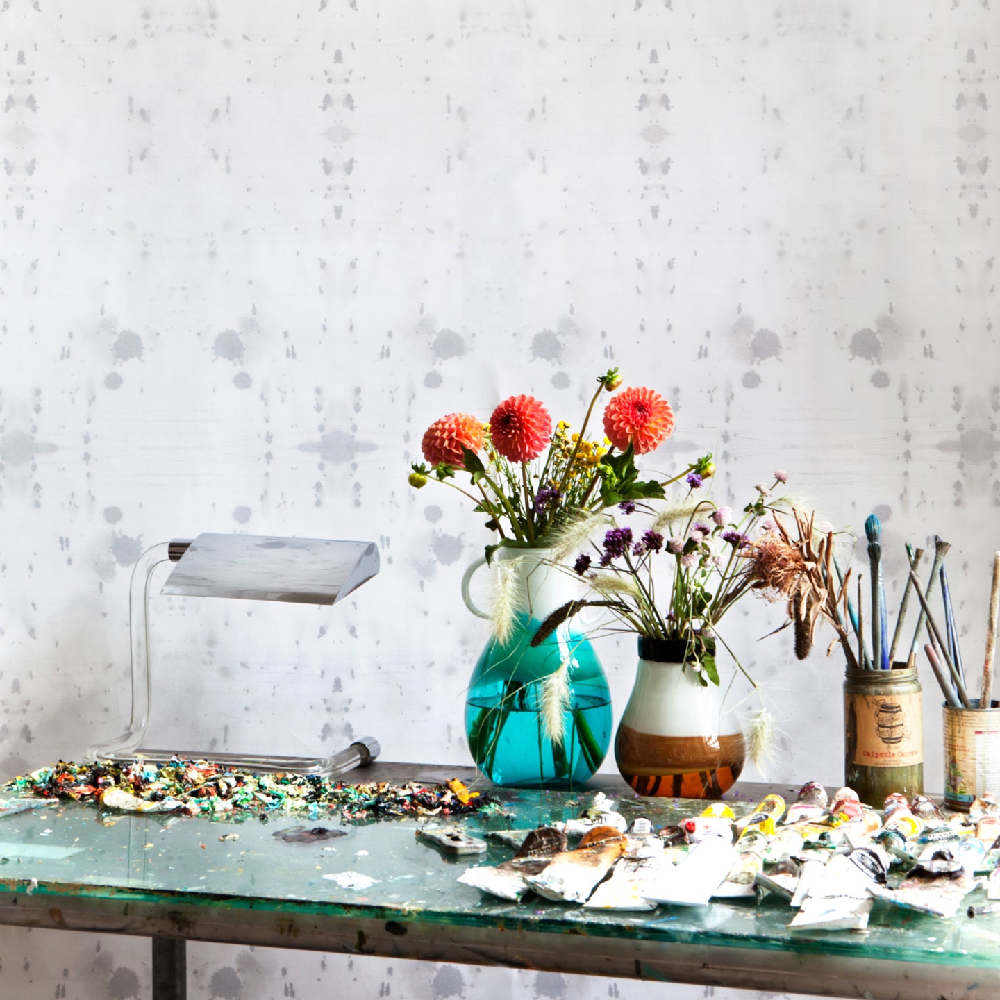 A glass table with a vase of flowers on top