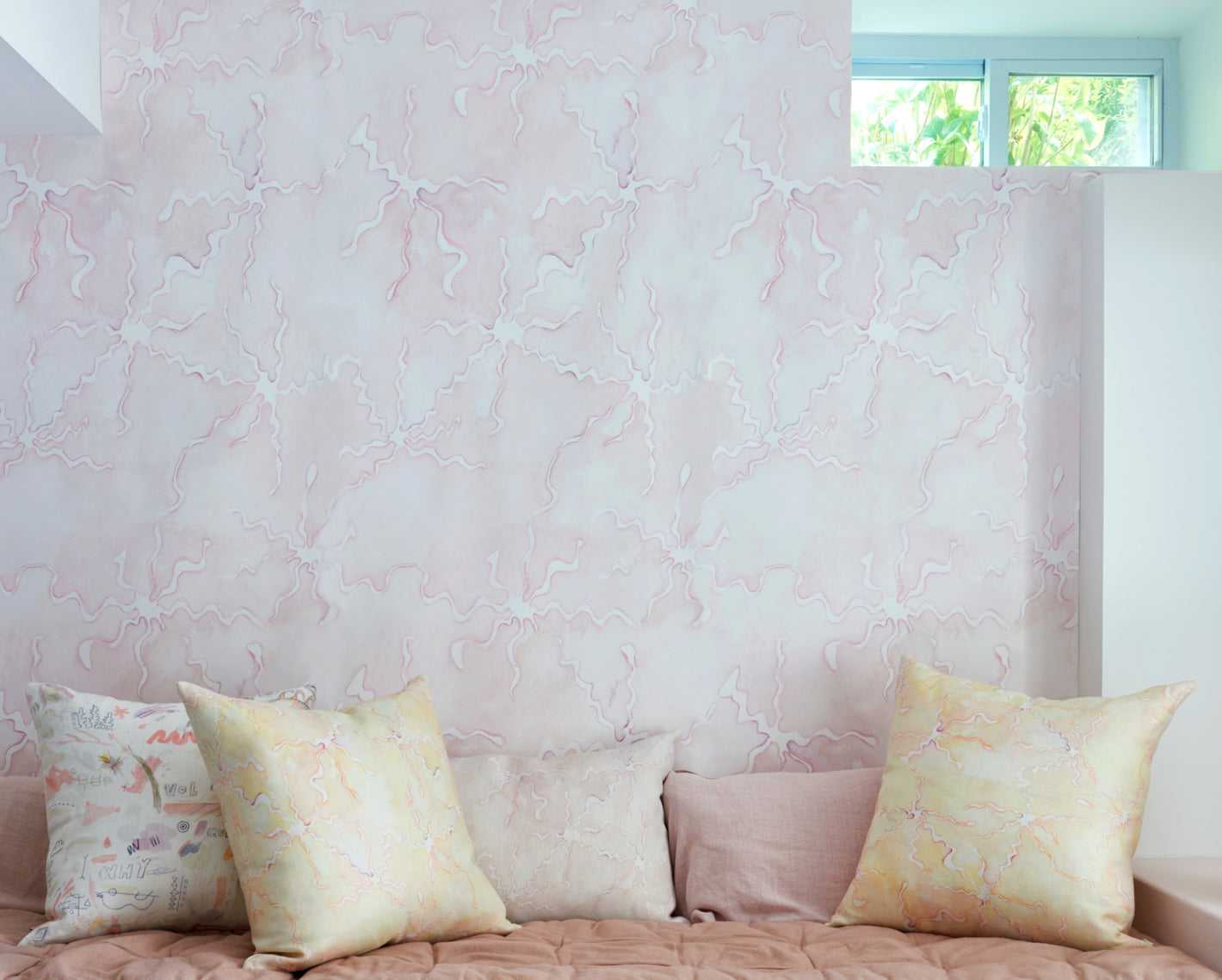 Pink marble wallpaper adorns the walls of a living room