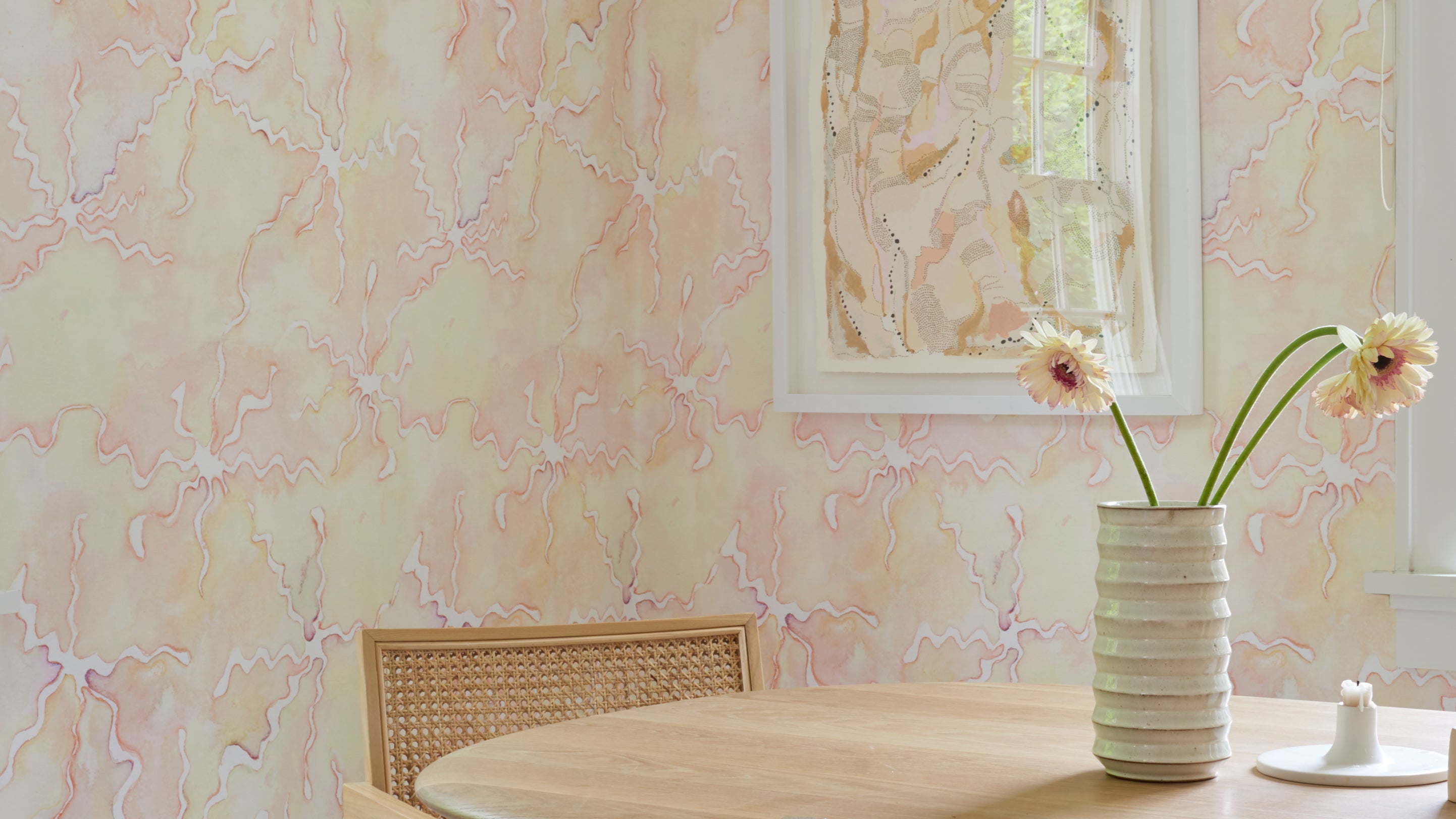 A table with a vase of flowers in front of it
