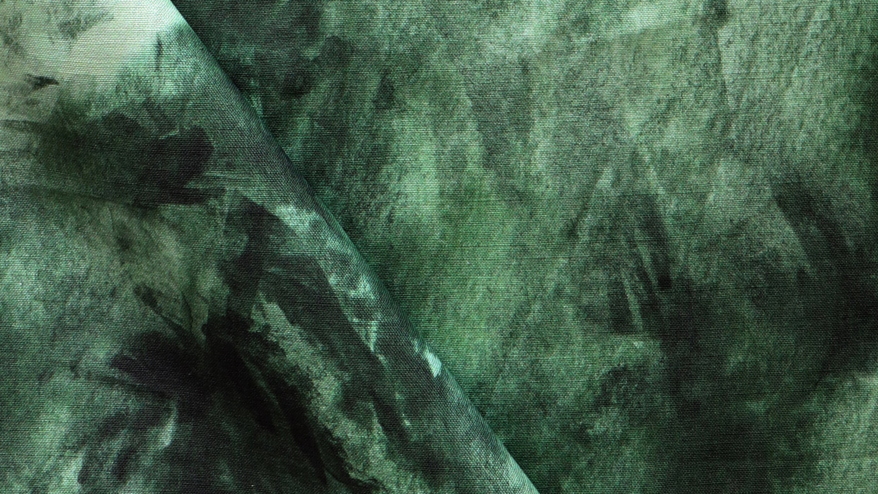 A close up of a green tie dyed fabric