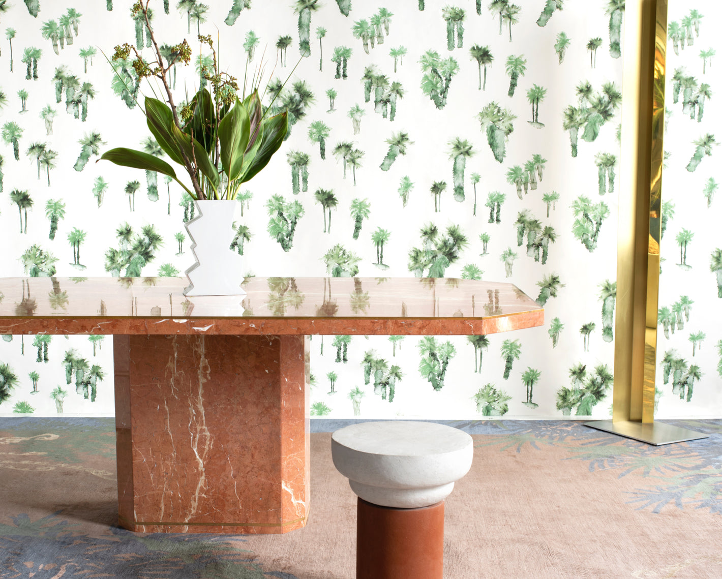 A table with a palm tree wallpaper and a vase of flowers