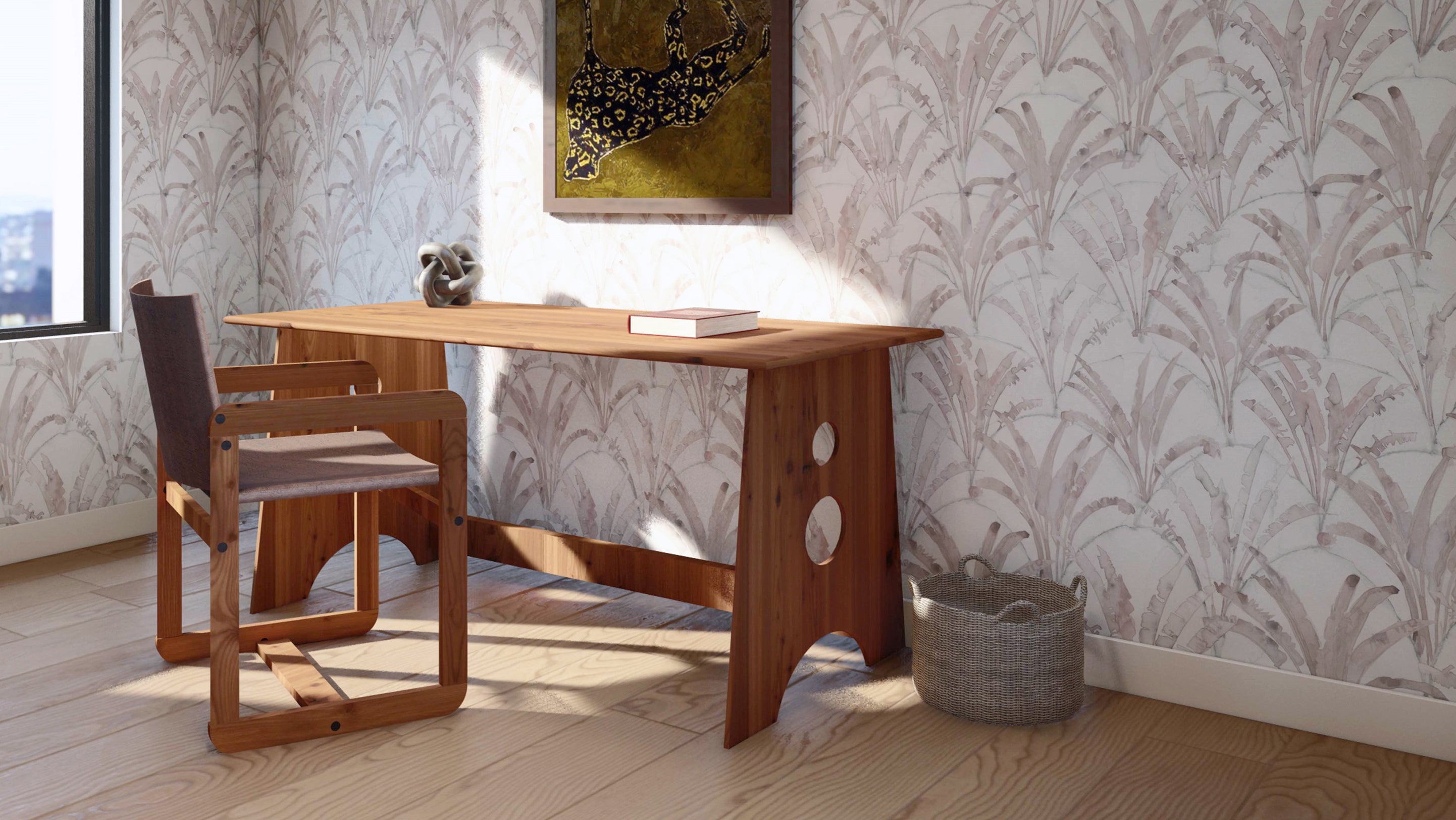 A desk and chair in a room with wallpaper