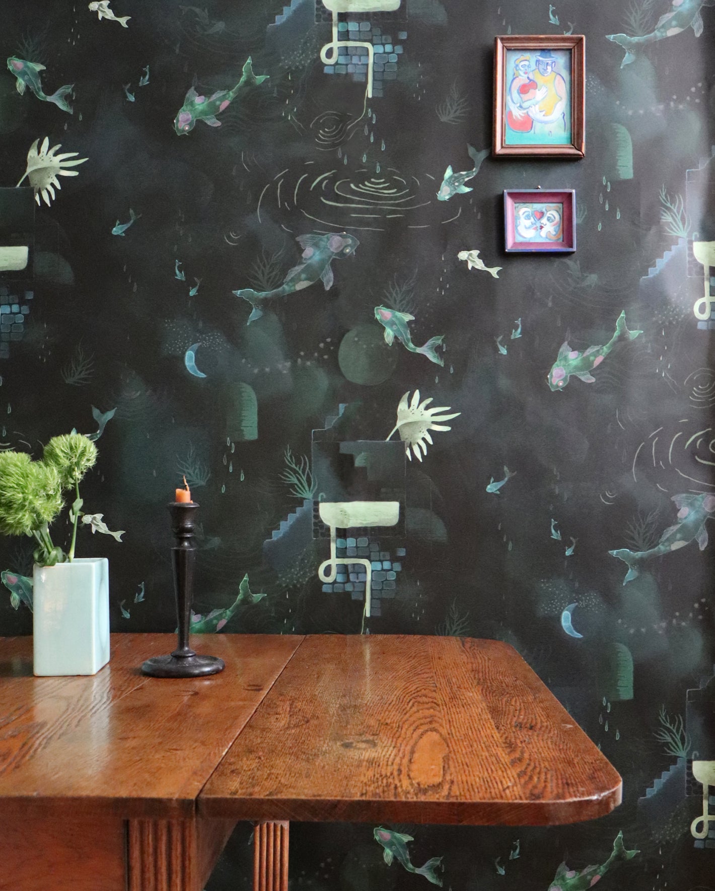 A dining room with a table and chairs and black wallpaper