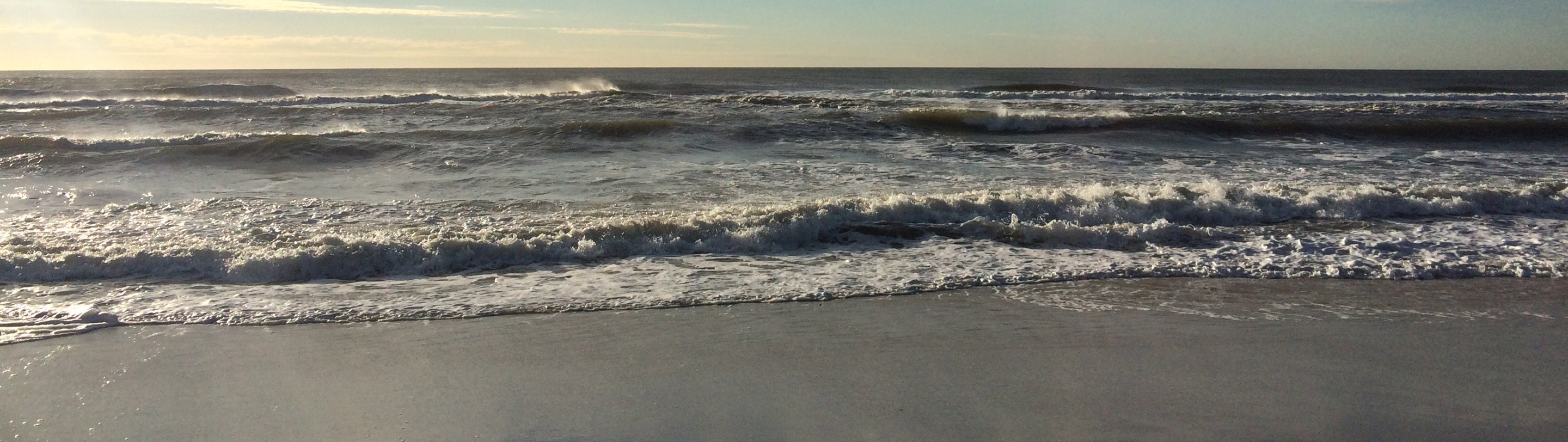 The waves are breaking on the beach
