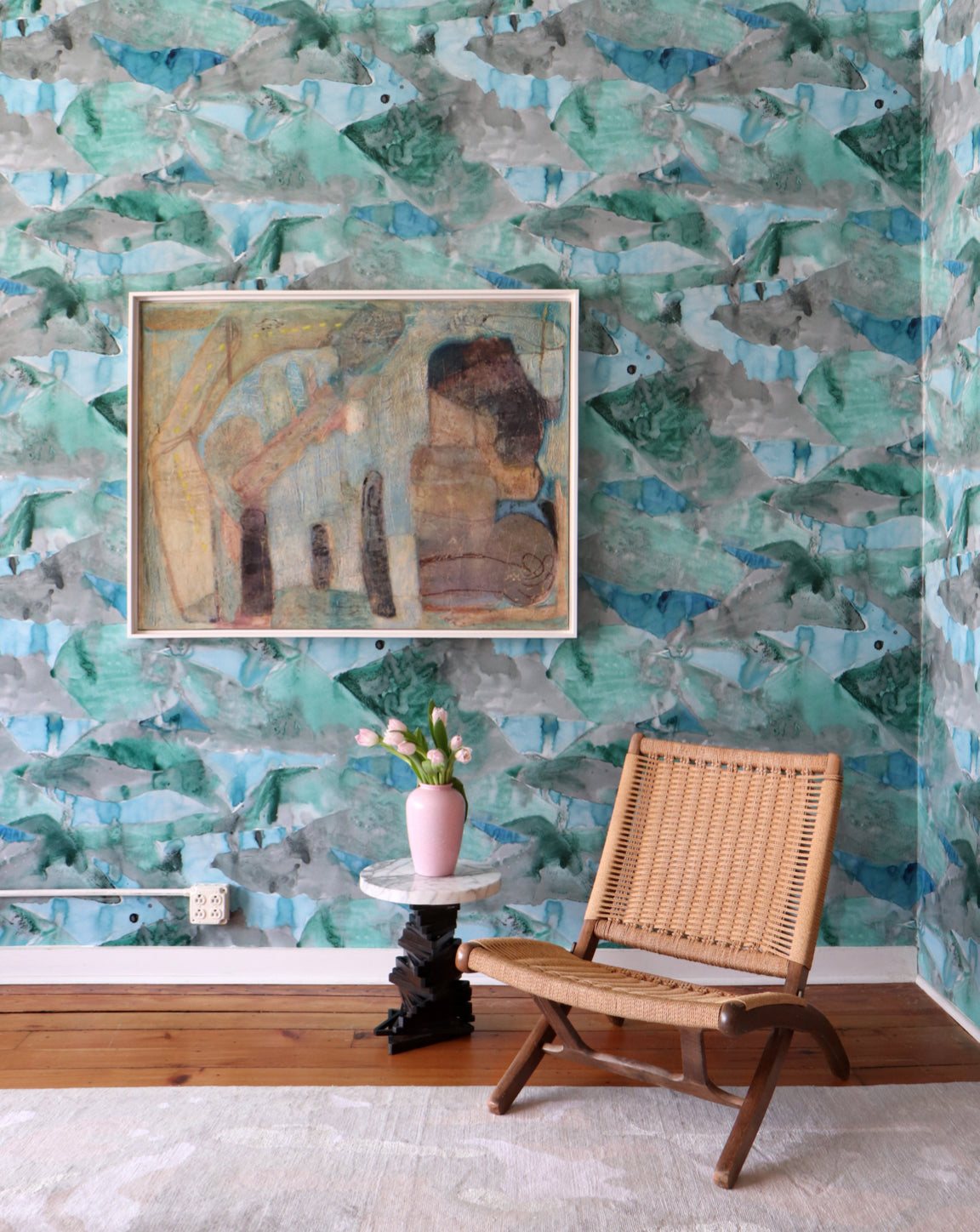 A room with blue wallpaper in front of a chair