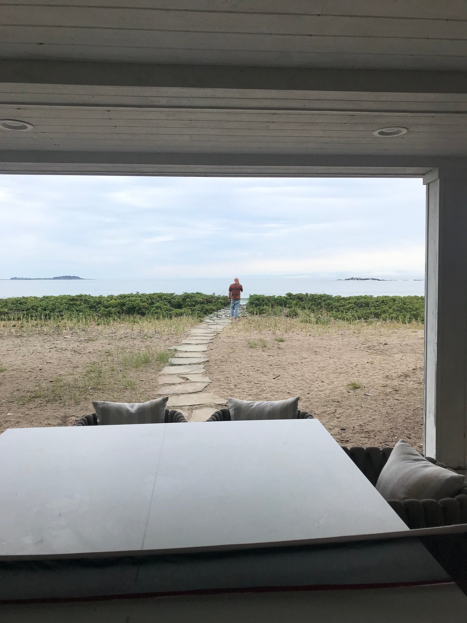 A view of the beach from an open door