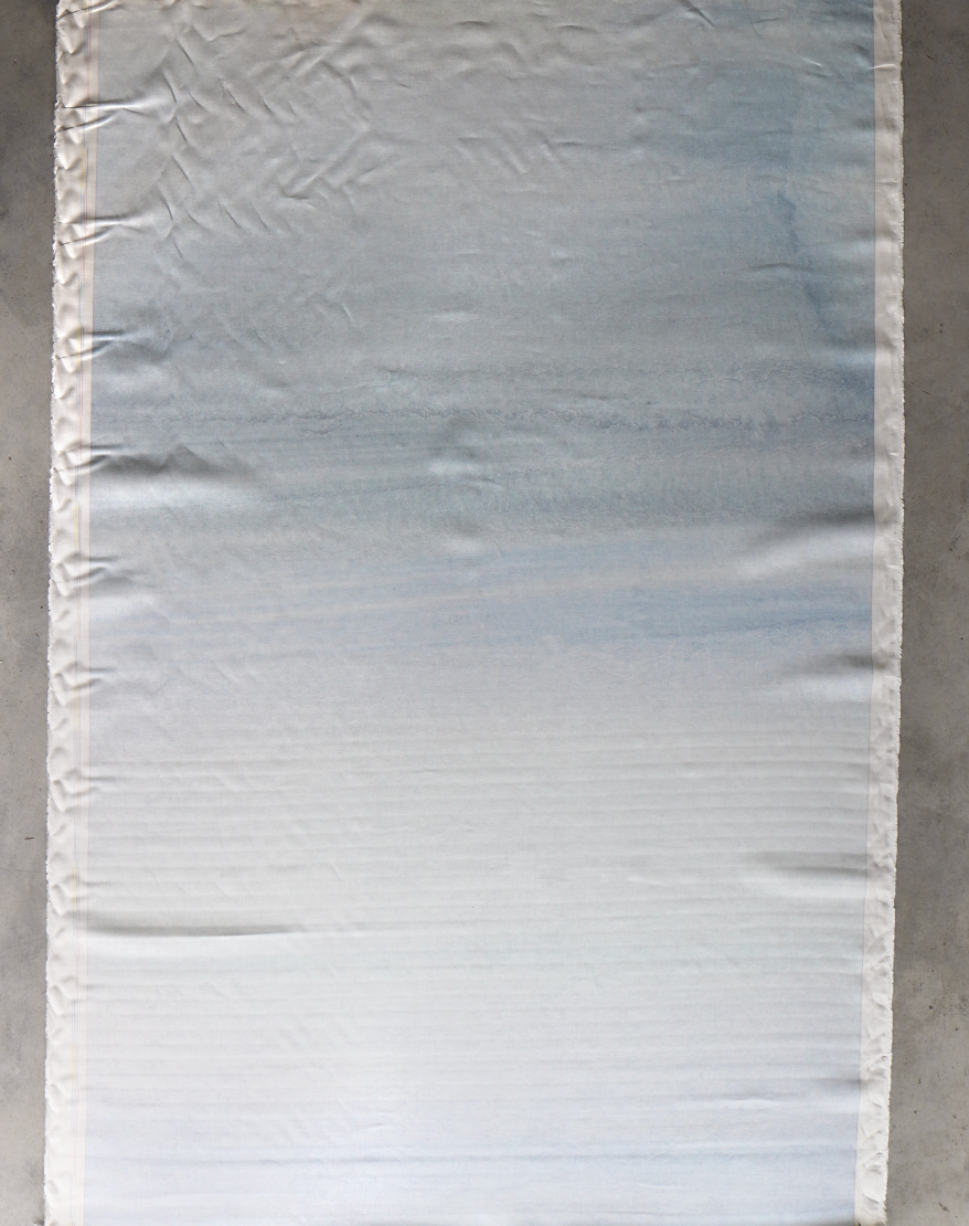 A large piece of Lily's View Fabric in the Dawn color, 54" wide with slight wrinkles, is laid flat on a surface.