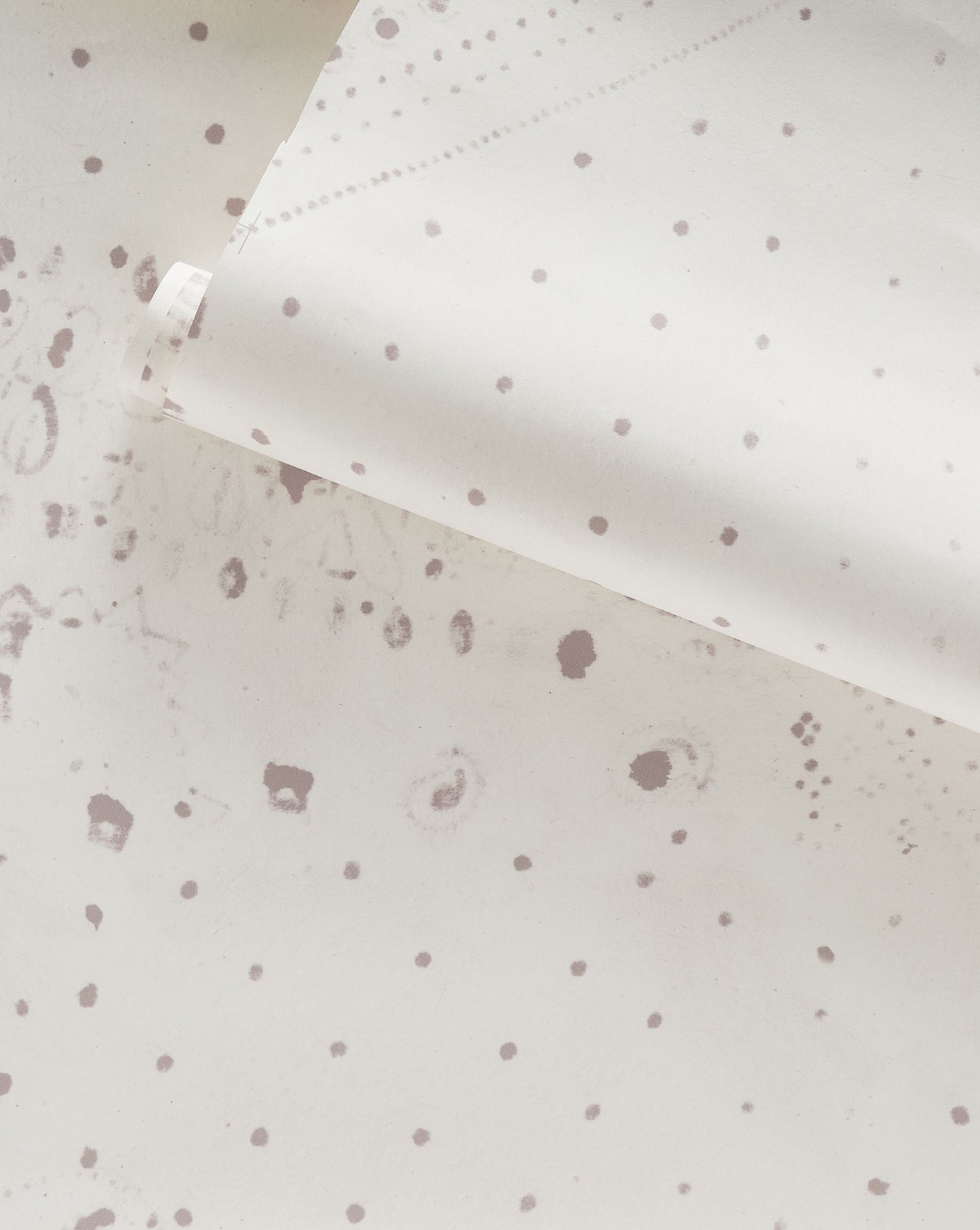 A white polka dot pattern on the Bandanarama Wallpaper Birch surface