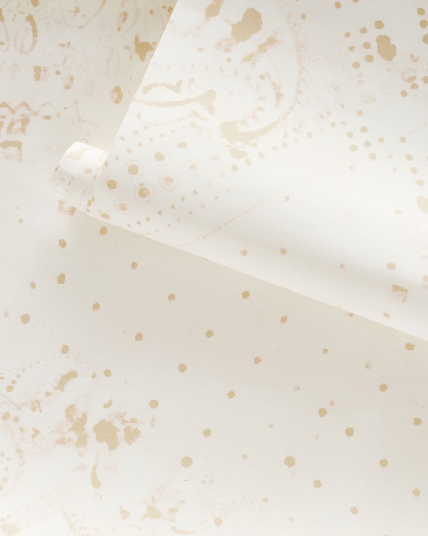 A Bandanarama Wallpaper flax with playful collage of gold polka dots on it