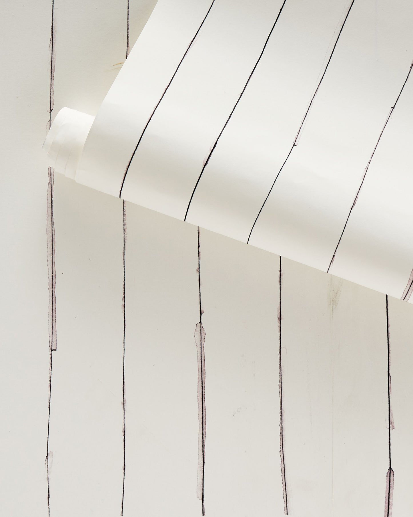 A luxurious Pen Stripe Wallpaper Ink in a classic black and white colorway