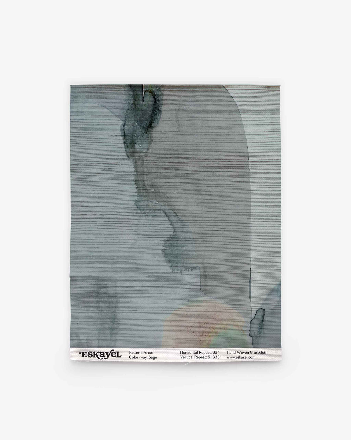A square fabric swatch features abstract watercolor-style gray, blue, and beige patterns. “ESKAYEL” is printed at the bottom alongside details for pattern, color, and repeat. Order an Arcos Grasscloth Sample in Sage to experience this unique design in person.