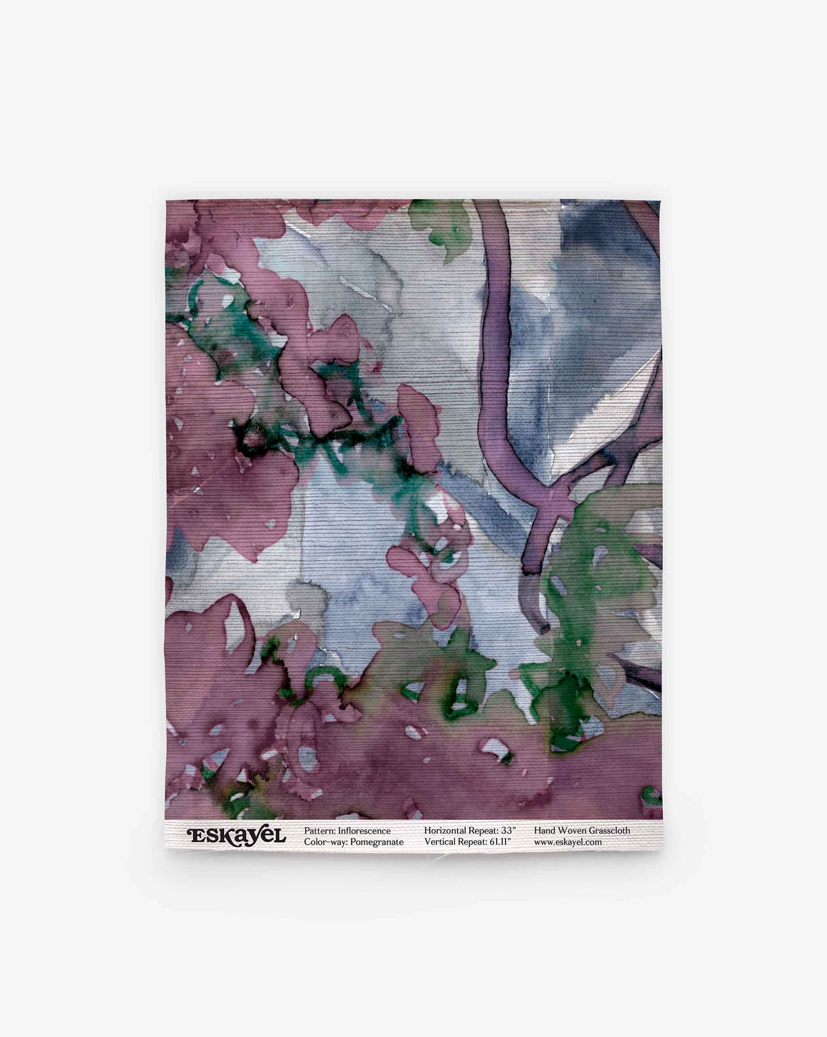 A square textile featuring abstract purple, green, and blue watercolor patterns, like wallpaper. Bottom text: Inflorescence Grasscloth||Pomegranate and a website URL.