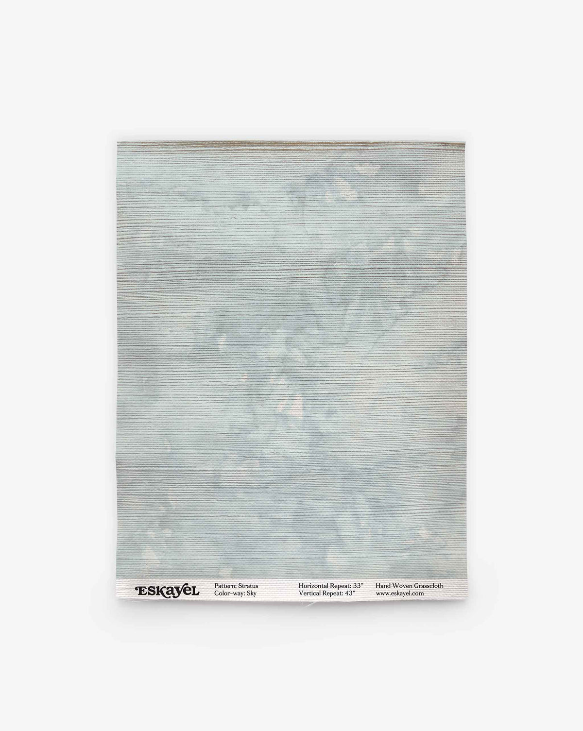 A square textile swatch in a light blue-gray hue with subtle horizontal lines and a mottled, grasscloth-like texture, labeled “Stratus Grasscloth||Sky” at the bottom.
