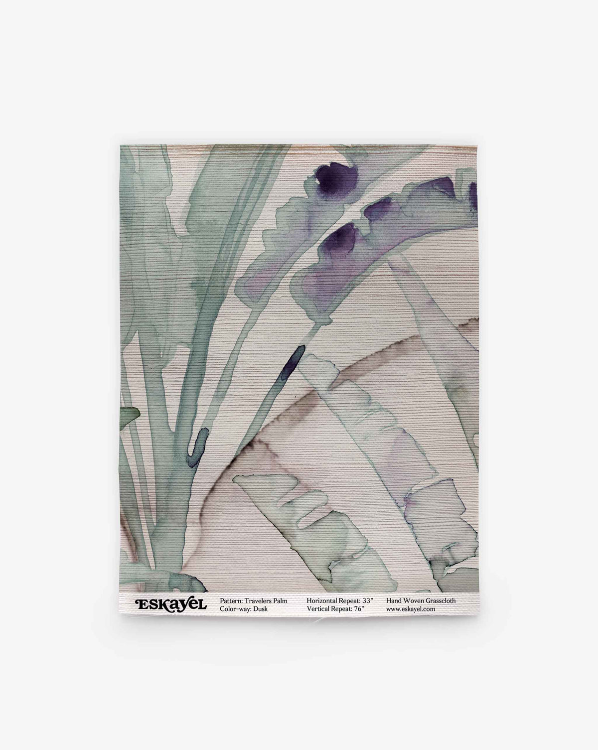 Travelers Palm Grasscloth Sample in Dusk, featuring a grasscloth wallpaper swatch with a watercolor print of large palm leaves in shades of green and purple.
