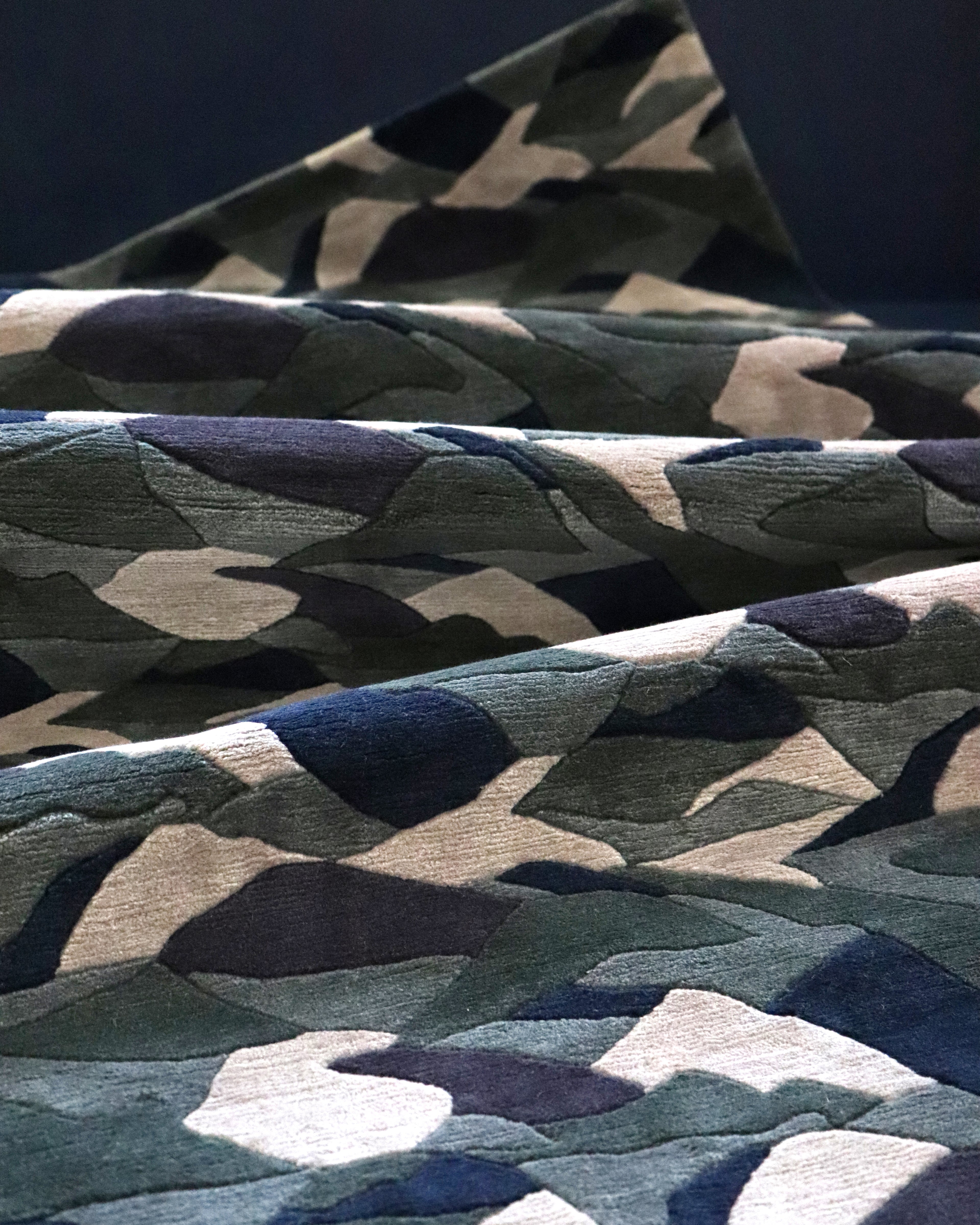 A close up of camouflage fabric on a bed