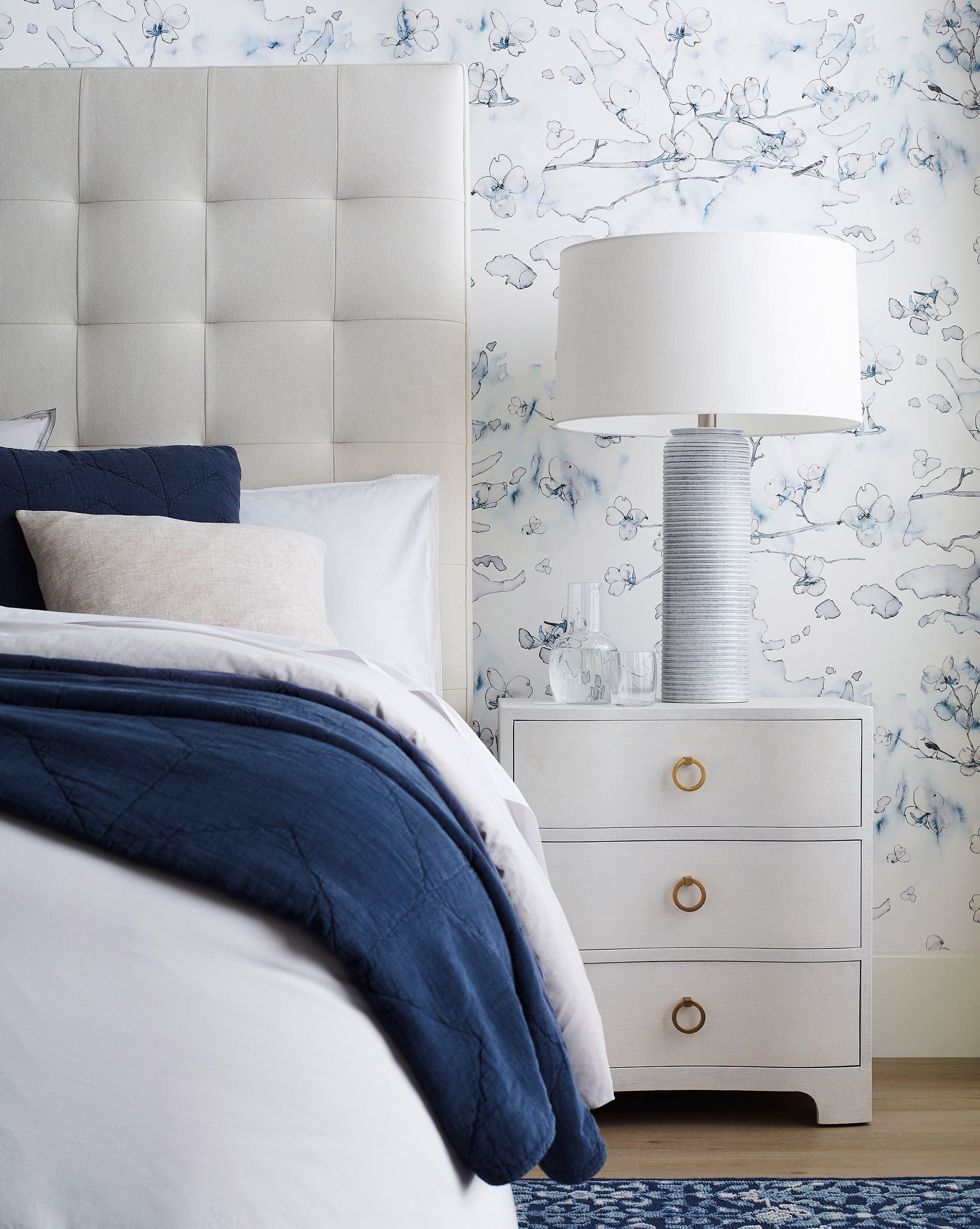 A bedroom with a Dogwood Dreams Wallpaper Indigo custom luxury wallpaper
