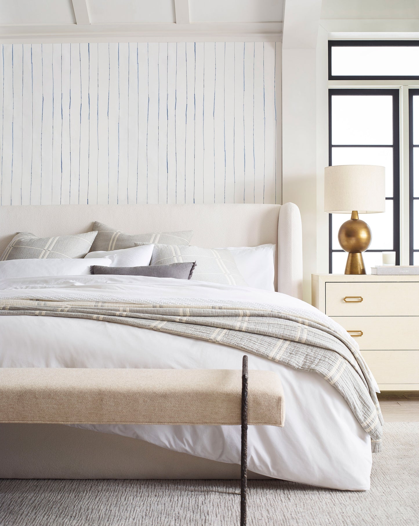 A bedroom with a bed and luxury Pen Stripe Wallpaper Indigo bench