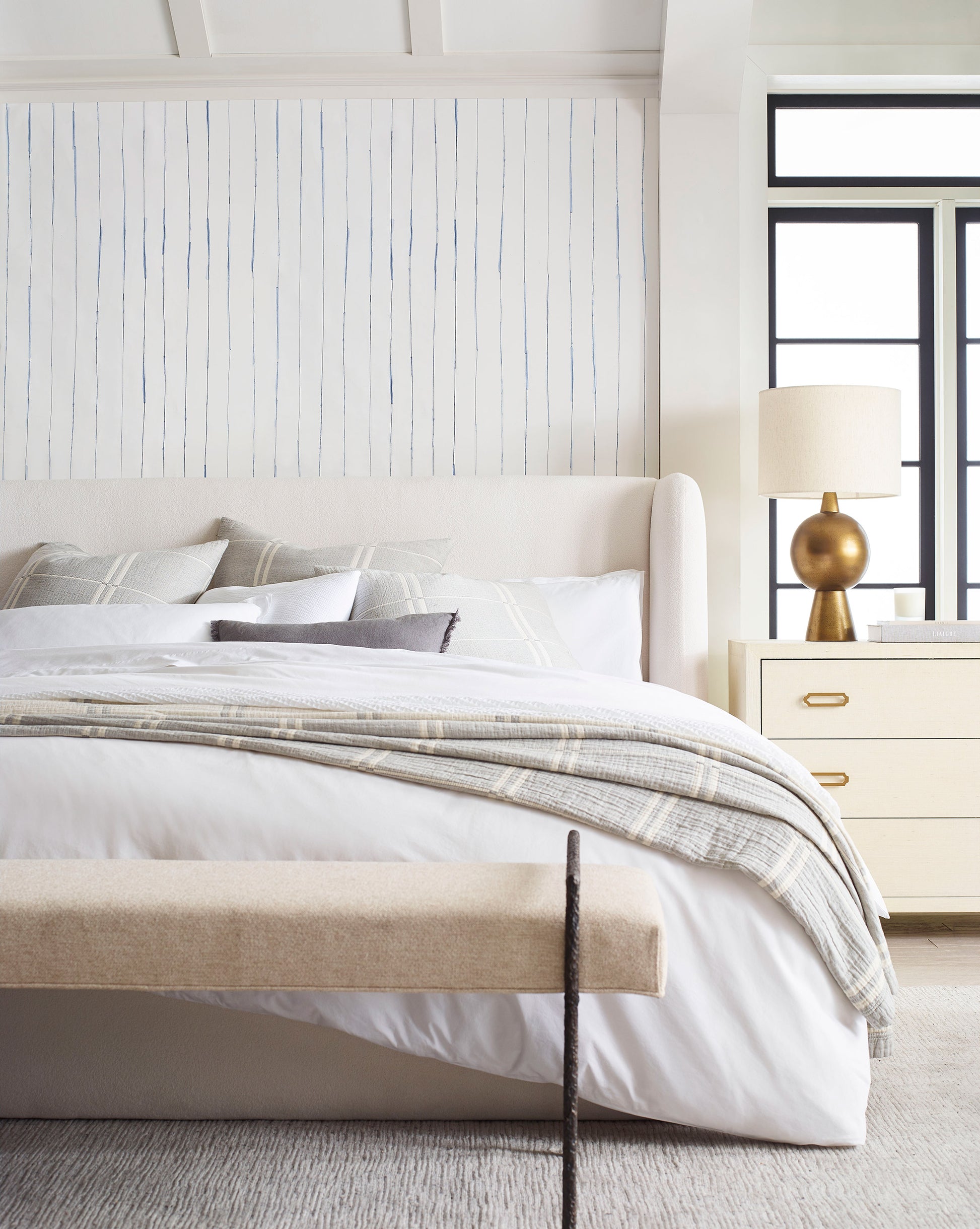 A bedroom with a bed and luxury Pen Stripe Wallpaper Indigo bench