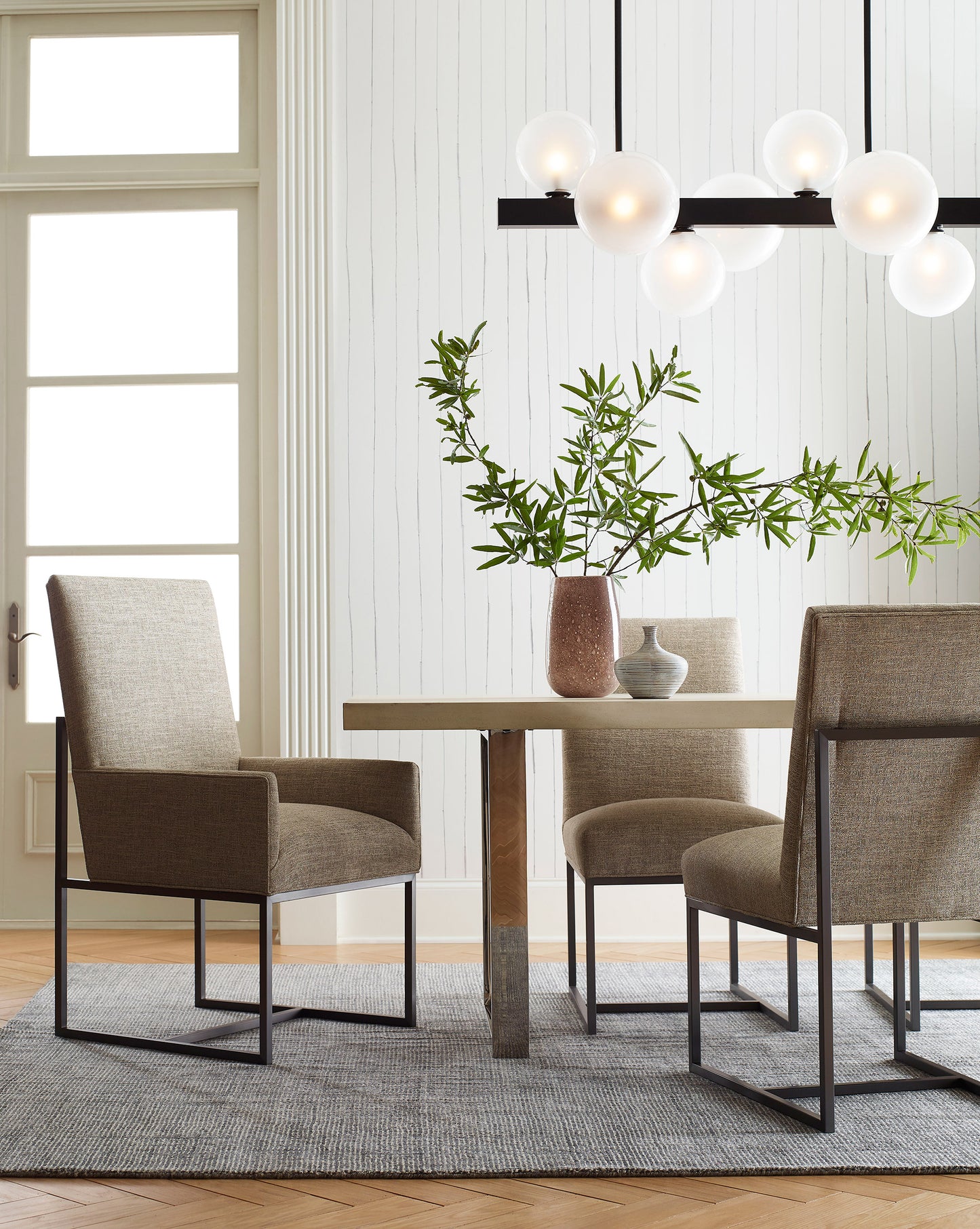 A dining room with Pen Stripe Wallpaper Ink table and chairs