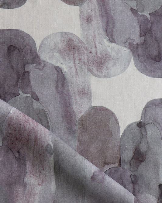 Luxurious Acros fabric in Pomegranate introduces magentas and greys into a soft geometric pattern of curves and columns