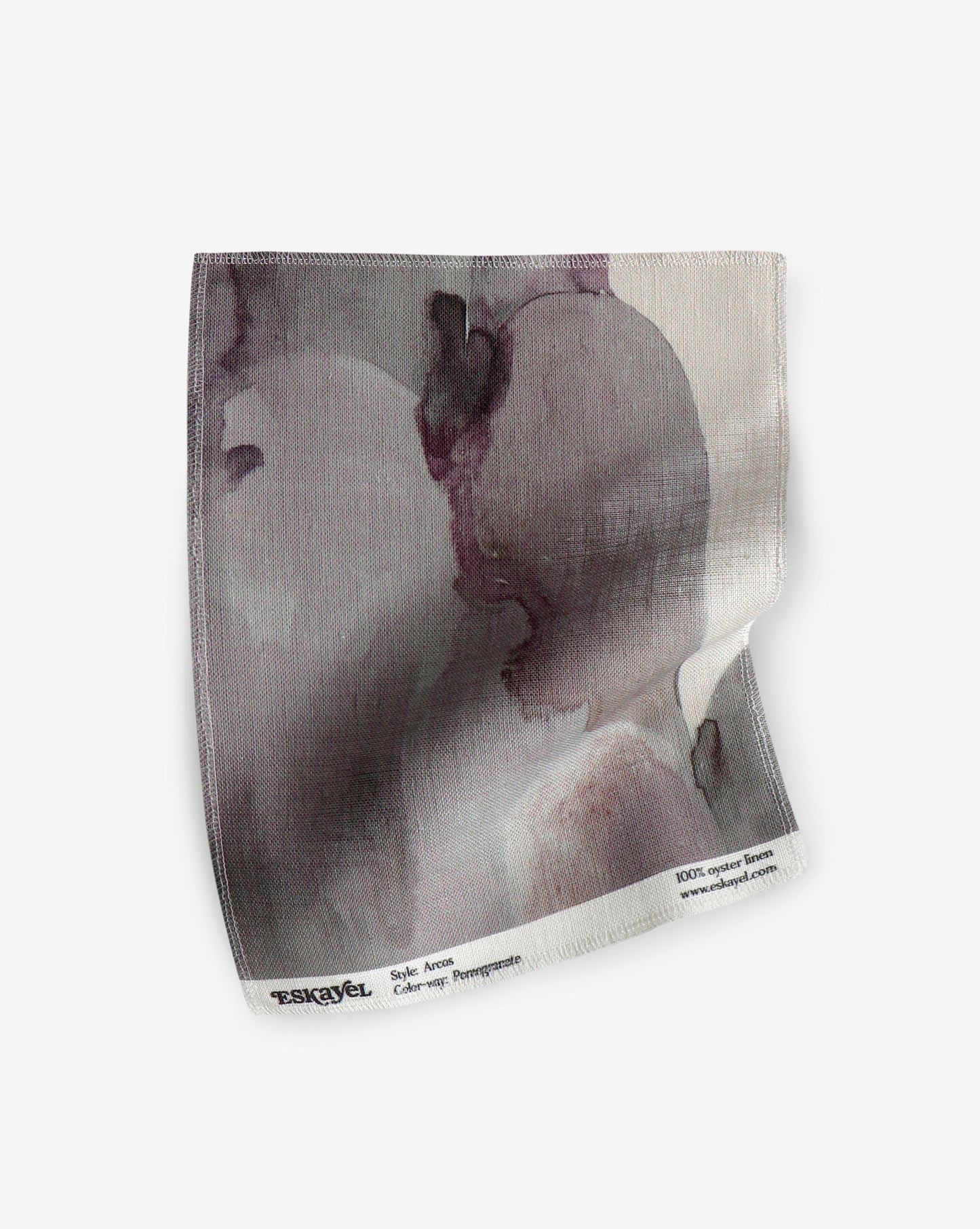 A sample of the Arcos Fabric Sample Pomegranate with a portrait of a woman on it