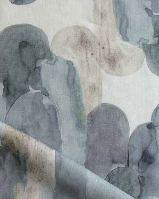 A close up of an Arcos Fabric Sage, a grey and white fabric with a watercolor pattern in the Sage colorway