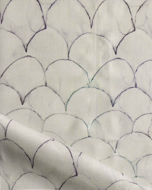 A close up of Baby Scallop Fabric Dusk, with a pattern of fish scales and geometric motifs