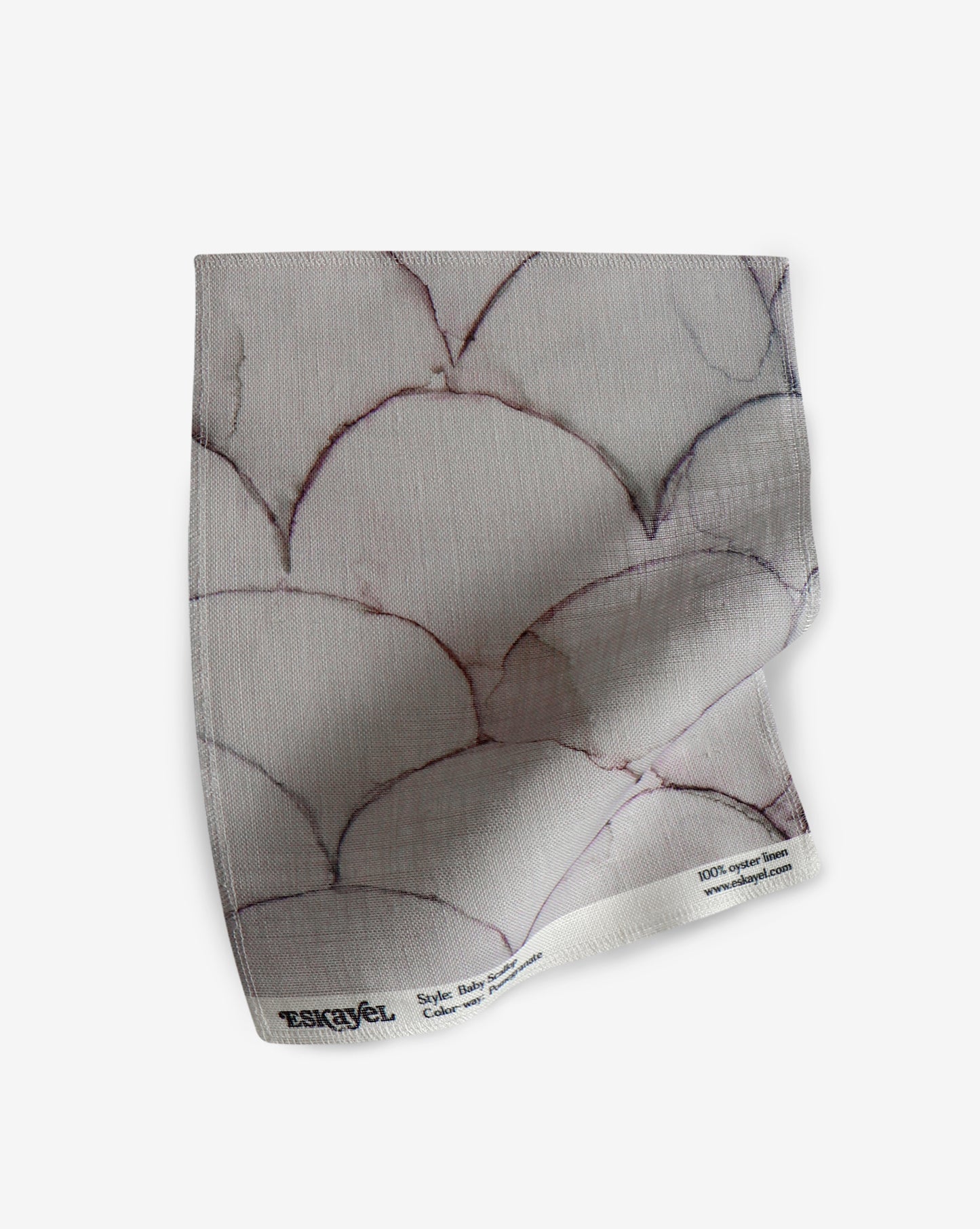 A white Baby Scallop Fabric with a pattern of geometric motifs