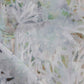 A close up of Cortile Fabric Aqua, a white and green painting on a fabric that can be used for rugs or pillows