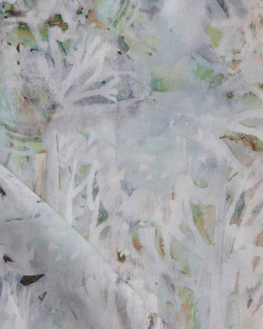 A close up of Cortile Fabric Aqua, a white and green painting on a fabric that can be used for rugs or pillows