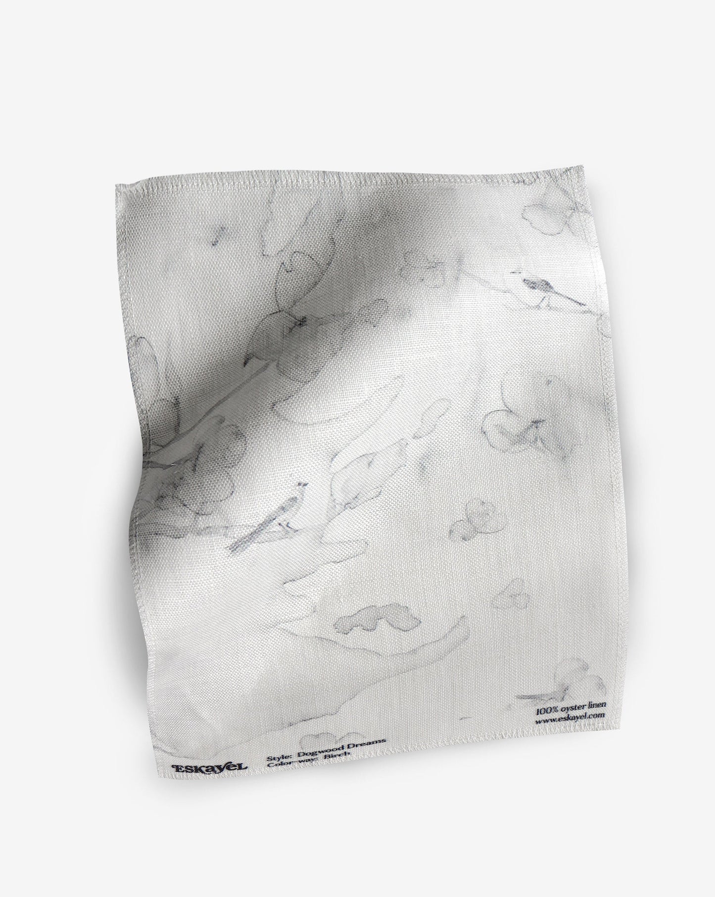 A white napkin with a Dogwood Dreams Fabric Sample||Birch pattern on it.