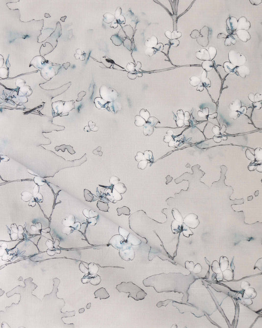 Dogwood Dreams is a botanical pen-and-ink pattern. As luxury fabric, Indigo classic grey is a colorway of beige and blue.