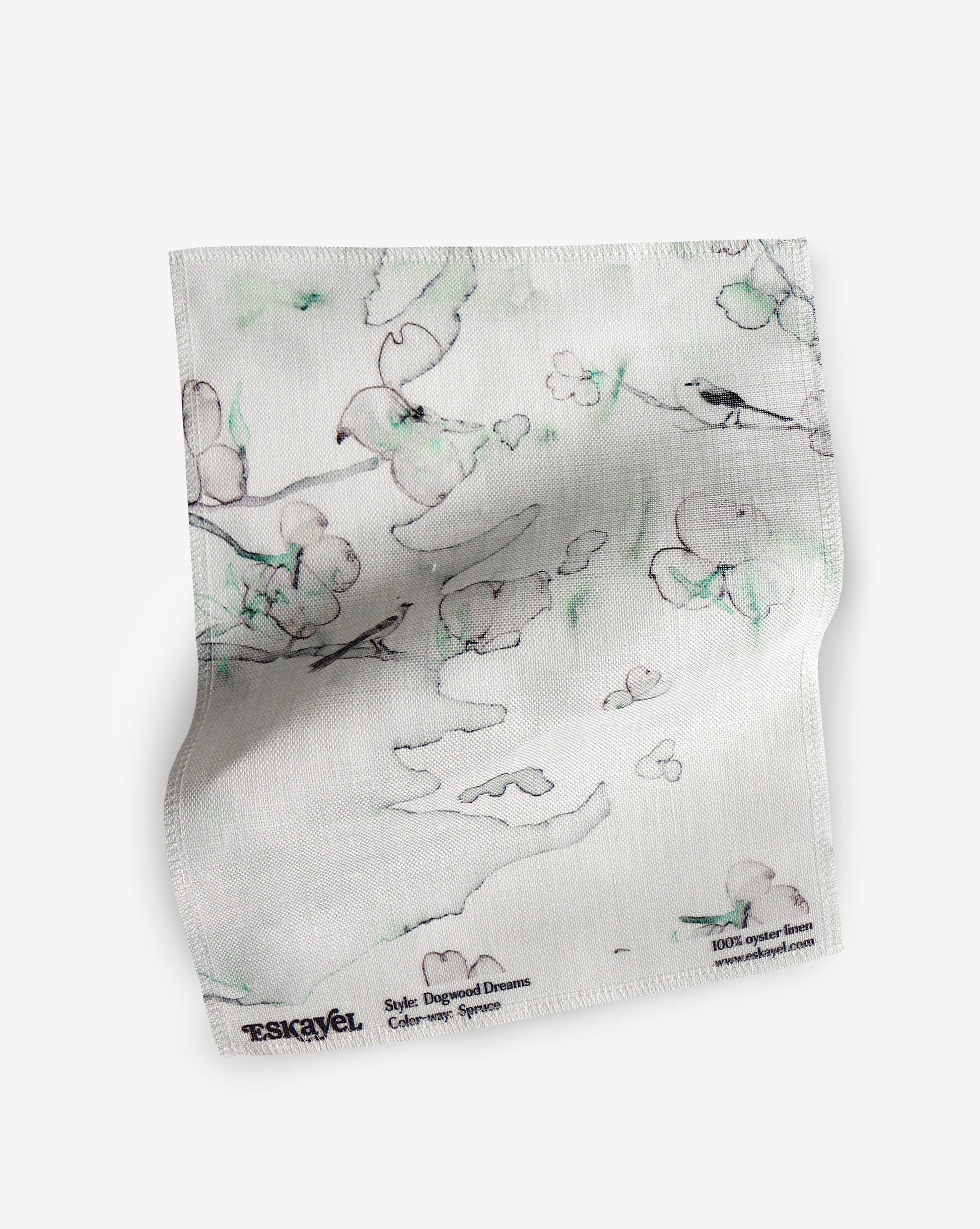 A fabric with our dogwood dreams pattern featuring a design of the dogwood tree, botanical elements, and birds in green, blue, and pink.