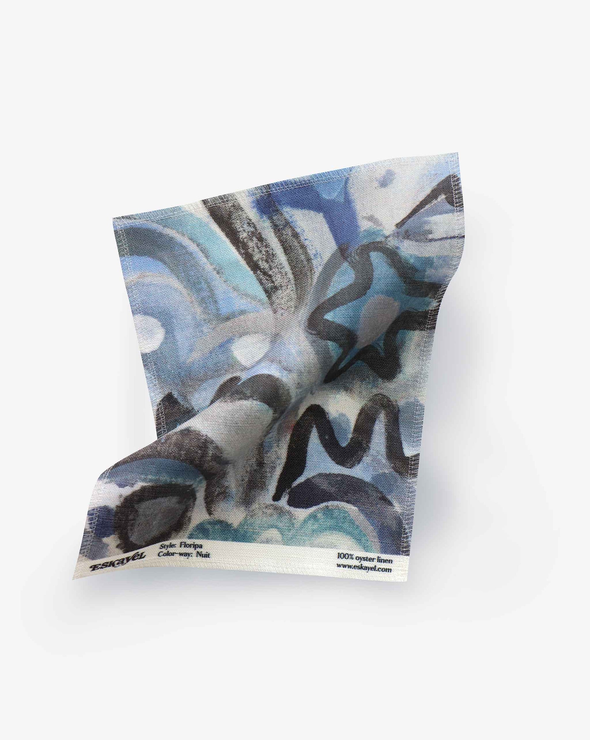 A fabric swatch with our Floripa pattern in Nuit featuring a design inspired by the beautiful tropical island of Florianopolis in Brazil that has a palette of blues.