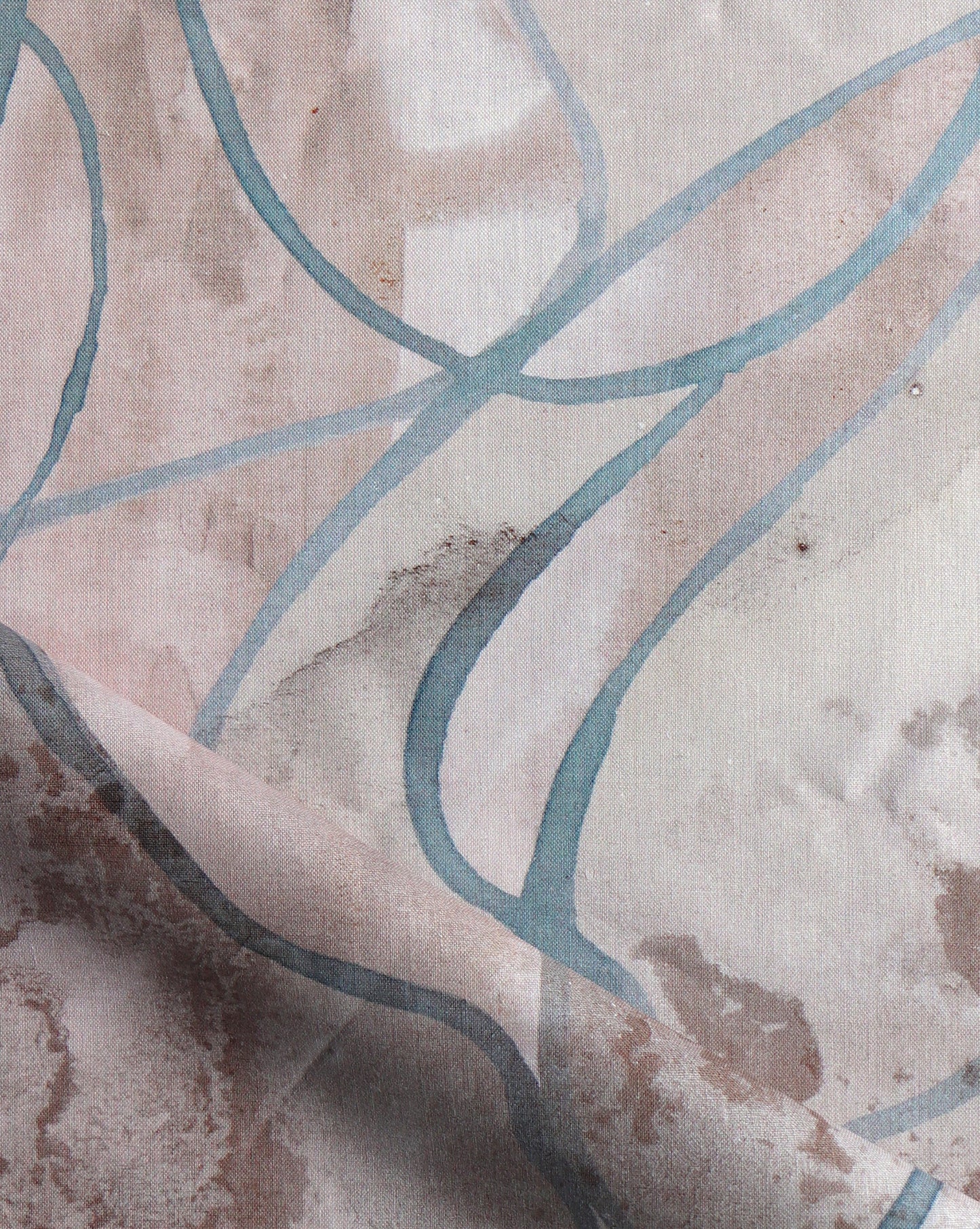 Watercolor strokes of beige, grey, and brown feature in Hibiscus Lily fabric in Amber.