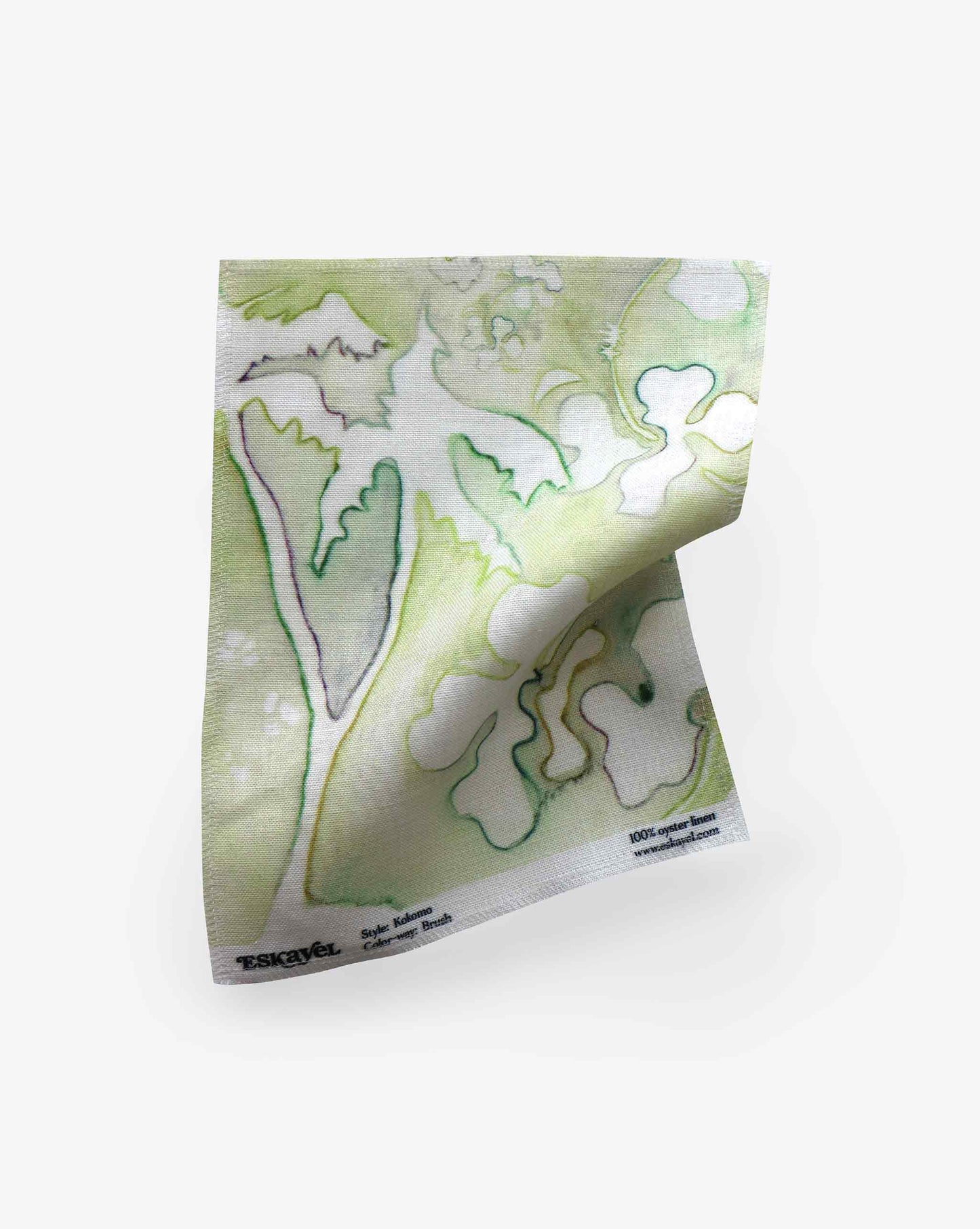 Order a sample of our Kokomo fabric with green botanical prints on a white background, displayed on a slight diagonal angle.