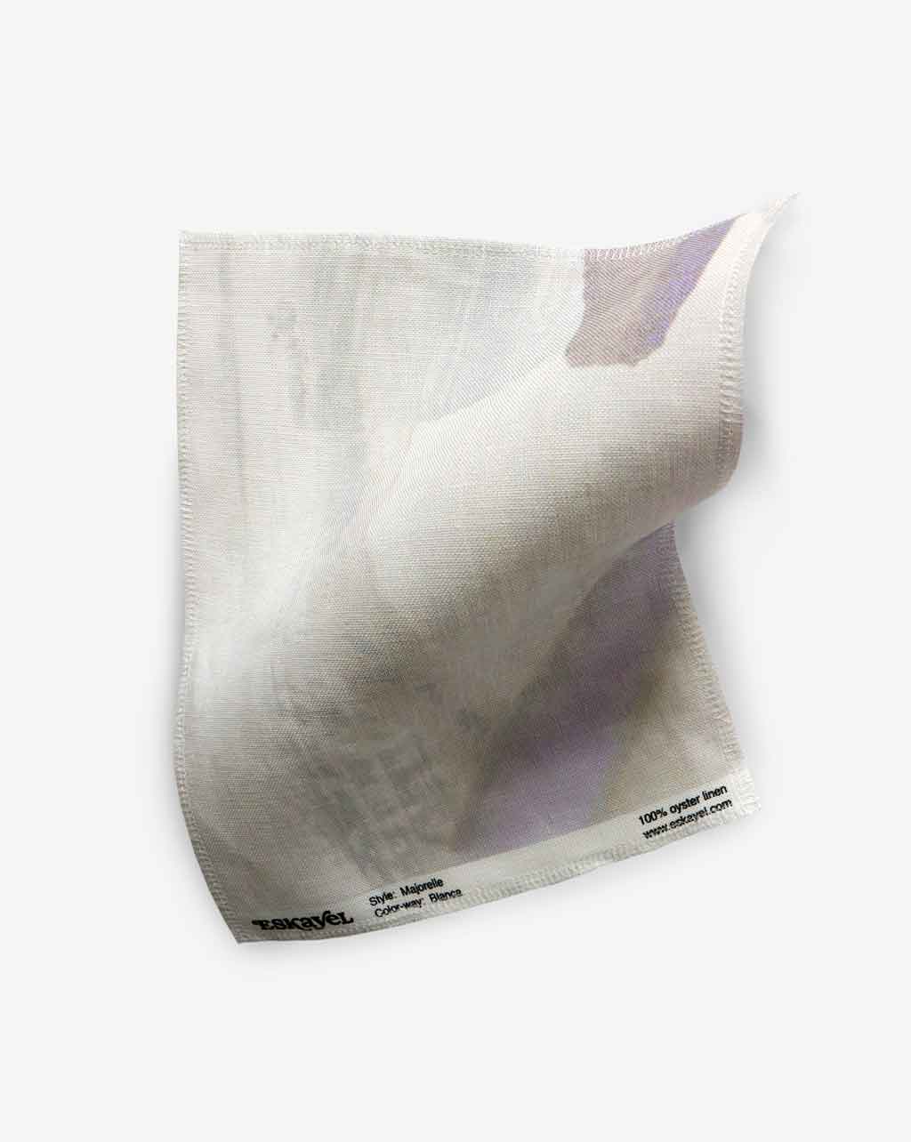 A single Majorelle Fabric||Blanca luxury microfiber cloth with a tag displaying text, isolated on a white background.