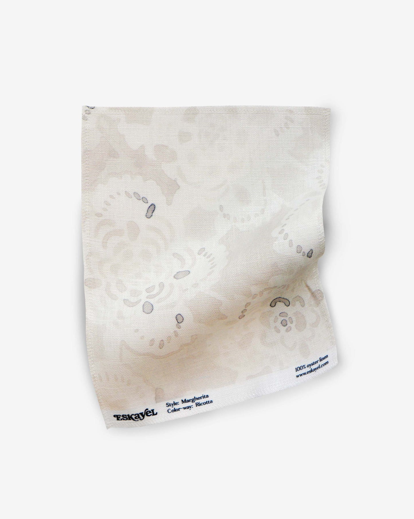 A square, light-colored Margherita Fabric Sample in Ricotta with a subtle floral pattern and text along the bottom edge, shown on a white background. Order a sample to experience its quality and design firsthand.