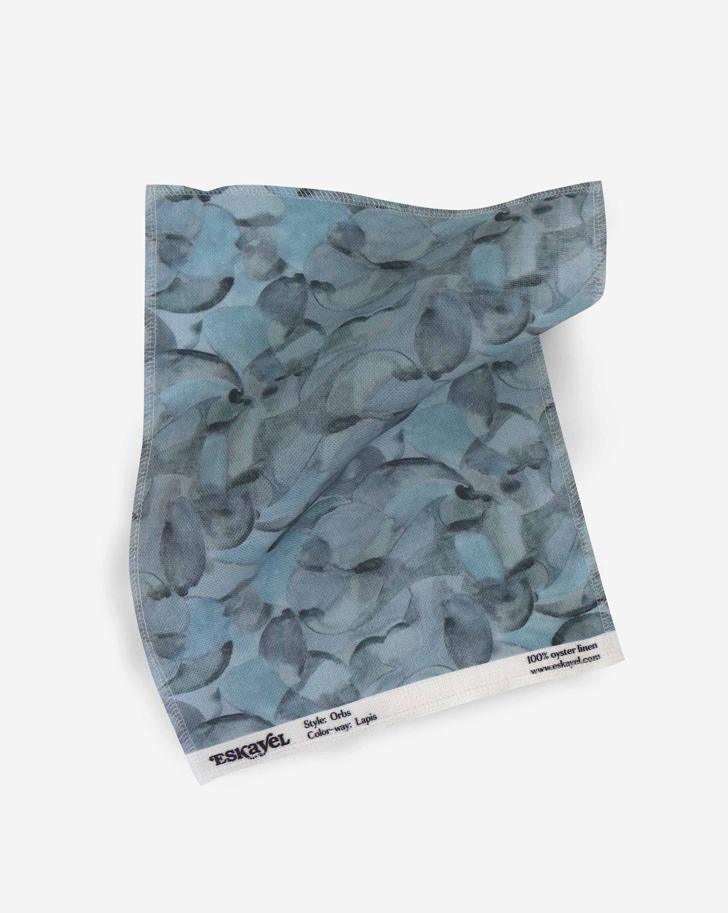 A fabric with our orbs pattern in the colorway lapis featuring a design of curved and spherical watercolor forms fill the field, creating an overall feeling of kinetic, playful harmony in shades of blue.