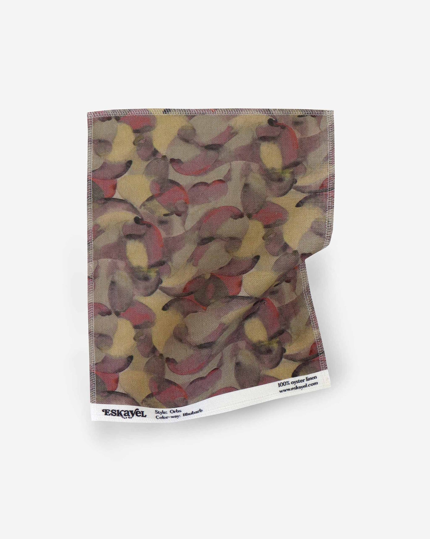 A fabric with our orbs pattern in the colorway rhubarb featuring a design of curved and spherical watercolor forms fill the field, creating an overall feeling of kinetic, playful harmony in an earthy multicolor palette.