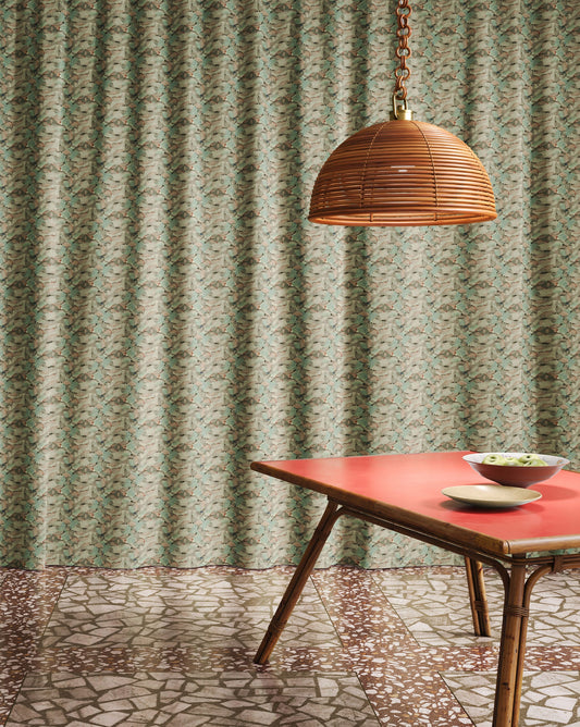Orbs tourmaline fabric in a green toned pattern used as curtains in a dining room.