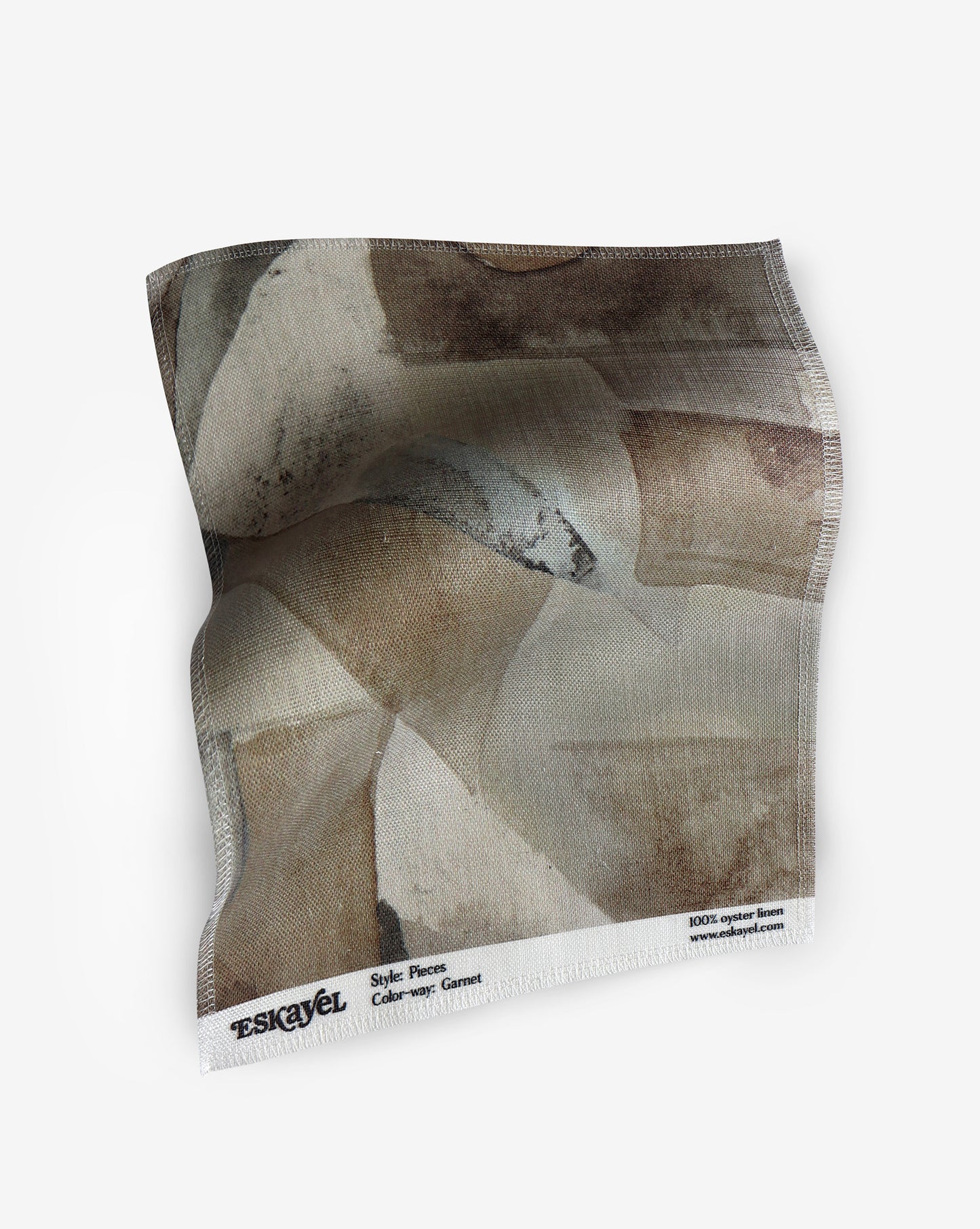 A fabric with our pieces pattern in garnet featuring a design of color blocked puzzle pieces in earthy brown shades.