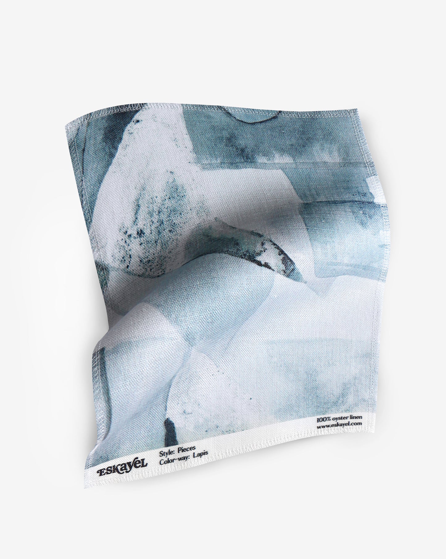 A fabric with our pieces pattern in lapis featuring a design of color blocked puzzle pieces in shades of blue.