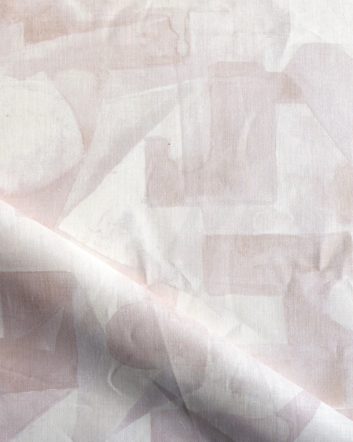 In Pieces fabric in the colorway Quartz, beige and pink blocks of pigment depict puzzle pieces.